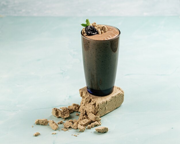 Glass of halva smoothie with smoothie with prunes