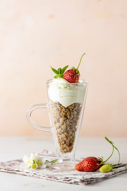 Glass of healthy breakfast with granola and greek yogurt close up