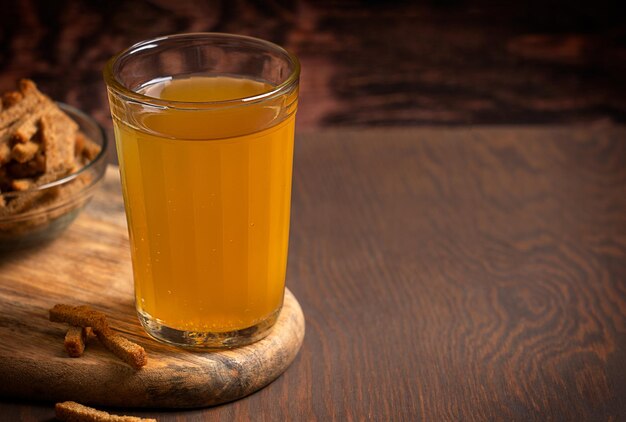 Glass of homemade refreshing cereal-based low alcoholic kvass beverage with sweet-sour taste