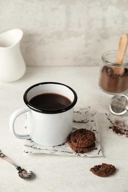 A glass of hot chocolate and pieces of chocolate on grey background Selective focus image