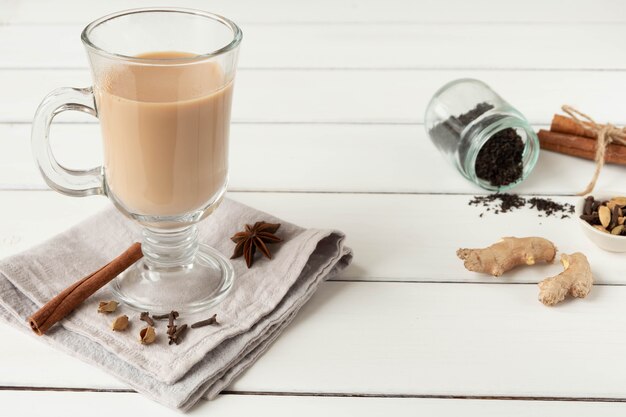 A glass of hot Indian masala tea brewed with aromatic spices and milk.