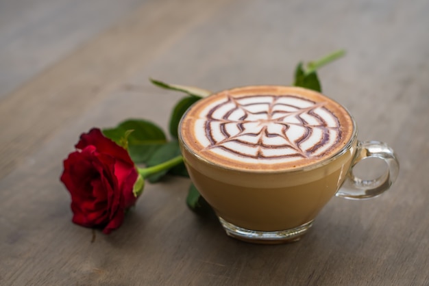 a glass of hot latte art coffee