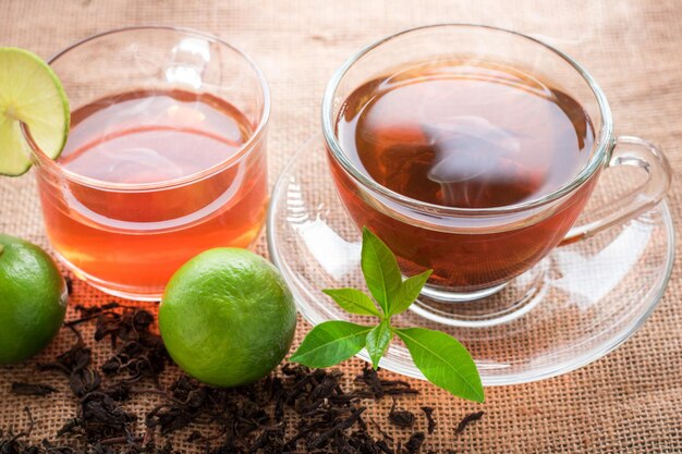 glass of hot tea on hemp sack and table in morning