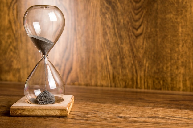 Glass hourglass on the table