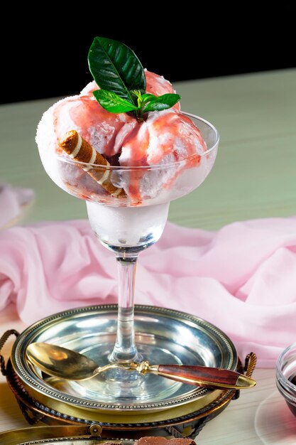 A glass of ice cream with a mint leaf on top