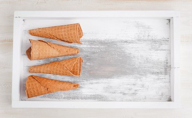 A glass of ice-cream on a wooden surface