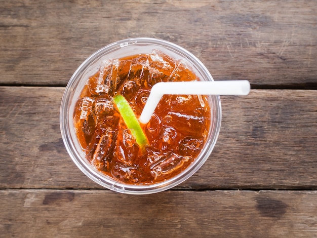 A glass of ice lemon tea on wooden table, 