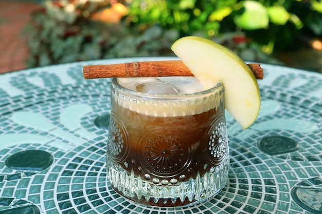 Glass of Iced Apple Cinnamon Tea on the Table