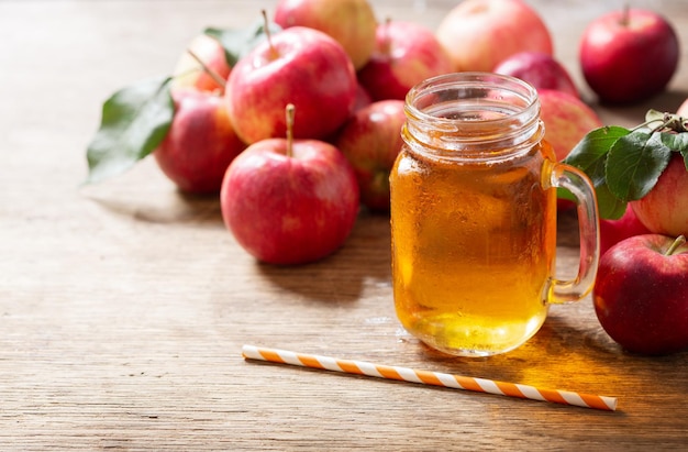 Glass jar of apple juice with fresh fruits