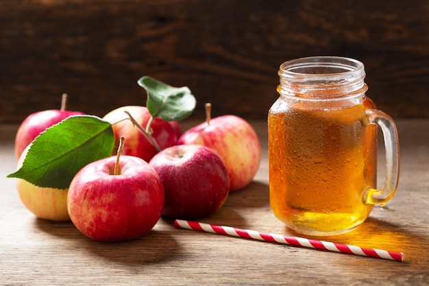 Glass jar of apple juice with fresh fruits