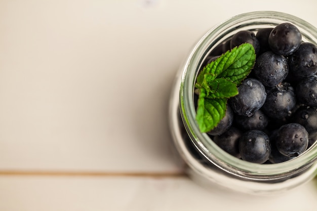 Glass jar of fresh blueberries