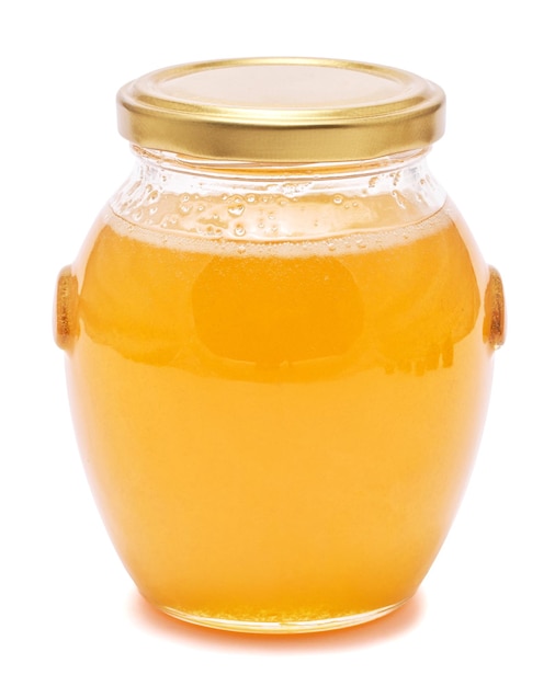 Glass jar of fresh honey isolated on white background