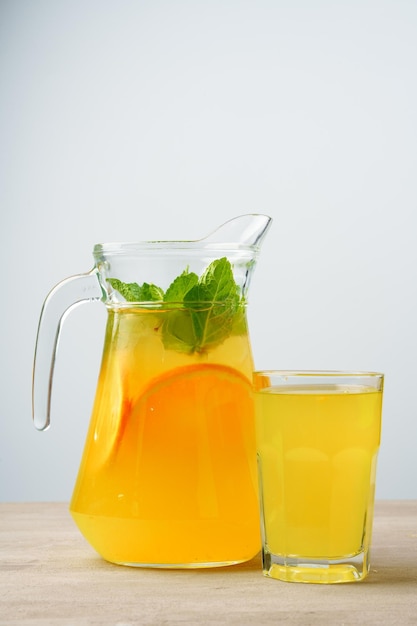 Glass jar of fresh lemonade on table close up