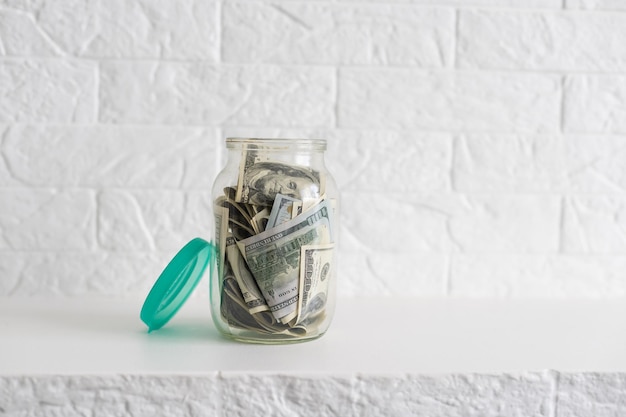 Glass jar full of the American banknotes.