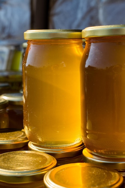 Glass jar of honey set with lid closeup