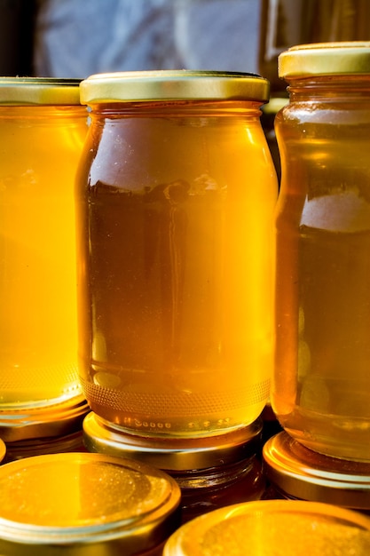 Glass jar of honey set with lid closeup
