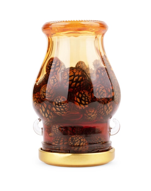 Glass jar of pine cone jam isolated on white