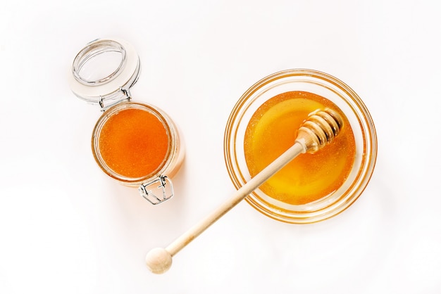 Glass jar and saucer with honey and a spoon for honey