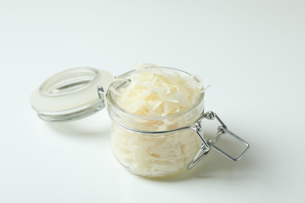 Glass jar of sauerkraut on white