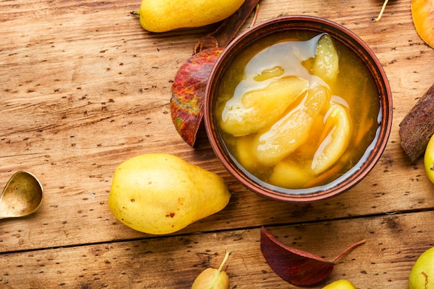 Glass jar with autumn homemade pear jam