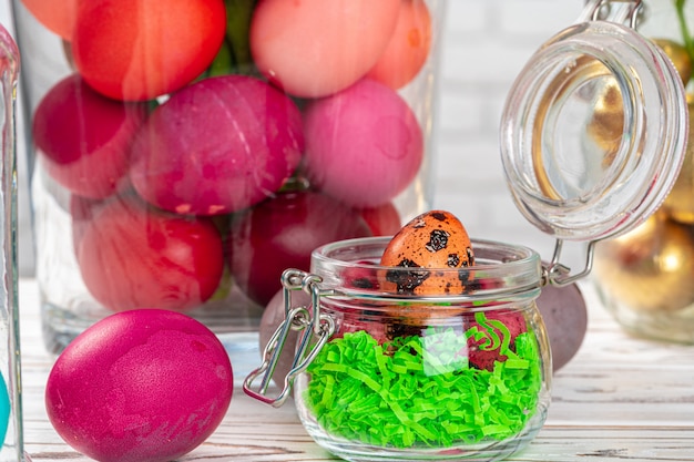 Glass jar with bright colored eggs for Easter celebration