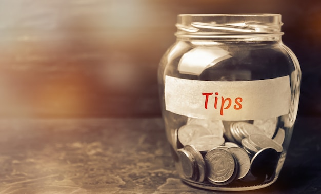 Photo glass jar with coins and the inscription tips