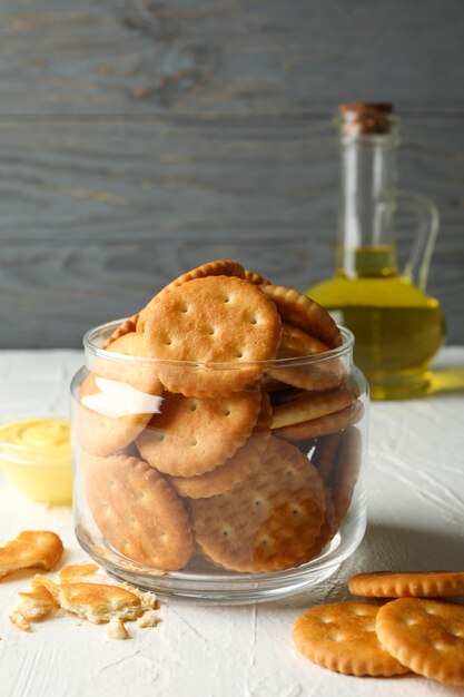 Glass jar with crackers, sauce and oil