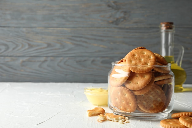 Glass jar with crackers, sauce and oil