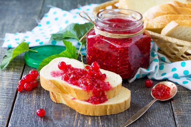 Photo glass jar with currant jam and mint leaves