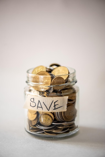 A glass jar with a label that says save on it.