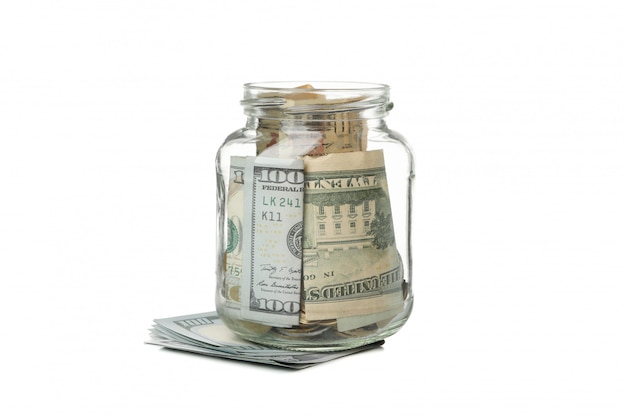 Glass jar with money isolated on white surface