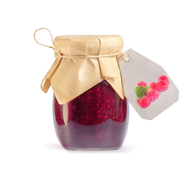 Photo glass jar with raspberry jam on white