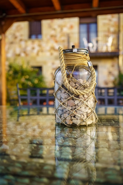 Glass jar with stones on top of a rustic country house table