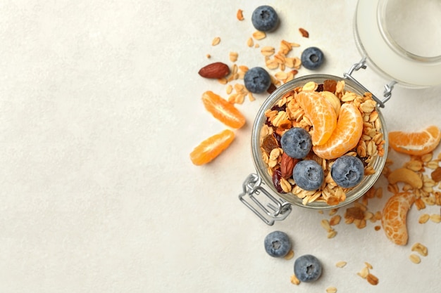 Glass jar with tasty granola isolated