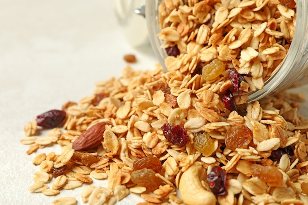 Glass jar with tasty granola isolated