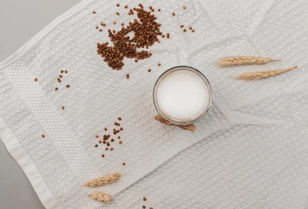 Photo glass jar with vegan milk buckwheat wheat self care concept vegan food