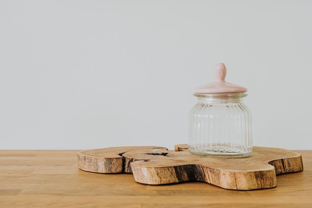 Glass jar on the wooden desk with copy space place