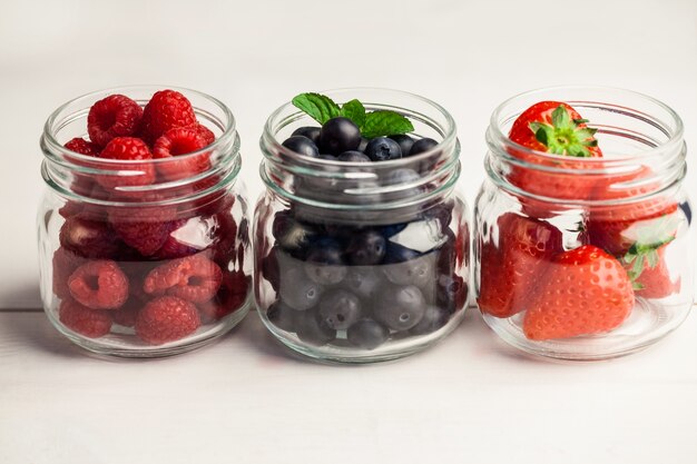 Glass jars of fresh berries