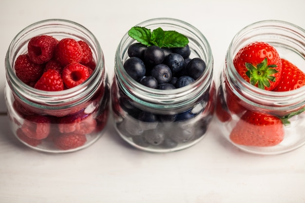 Glass jars of fresh berries