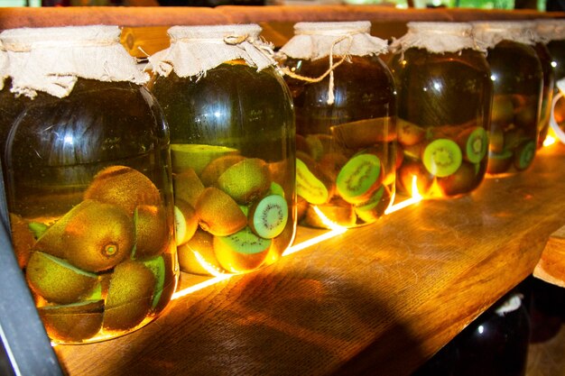 Glass jars with blanks for the winter. Fruit and berry preserves in a dark cellar. Useful workpieces