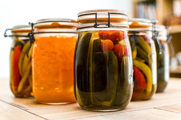 Glass jars with marinated food lacofermented peppers and vegetables