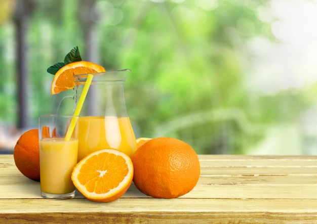 Glass and jug of delicious orange juice