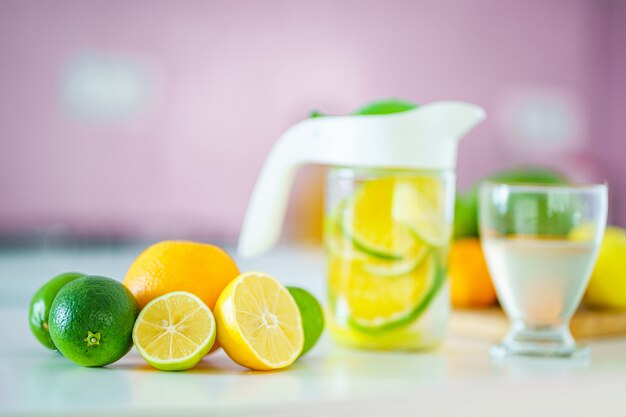 Glass jug with refreshing infused detoxification citrus water for vitamin detox drink.