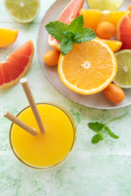 Glass of juice and citrus fruits