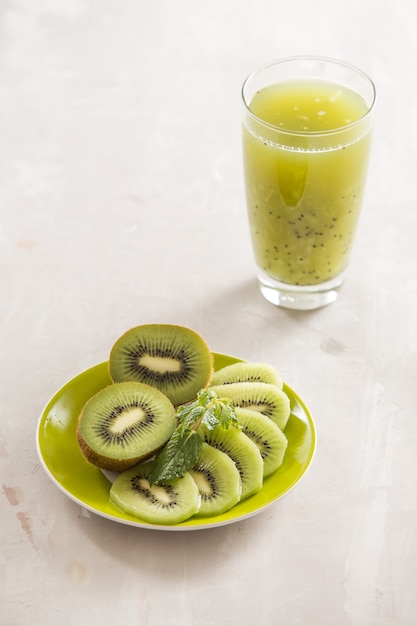 glass of kiwi juice with fresh fruits ontable