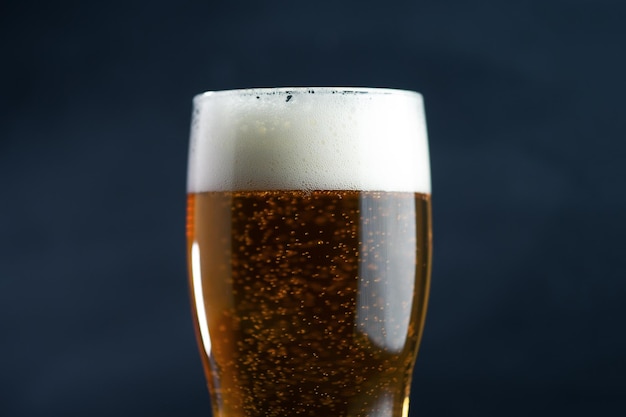 A glass of lager light beer on a dark background