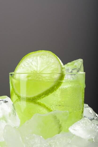 A glass of lemonade with lime on ice