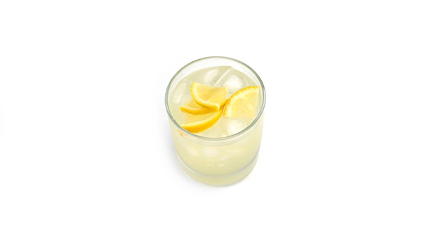 Glass of lemonade with slices of lemon and ice.