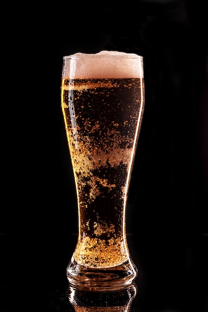 Glass of light beer. Full glass with lager beer, close up