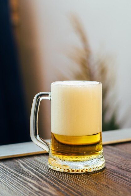 A glass of light beer on the table